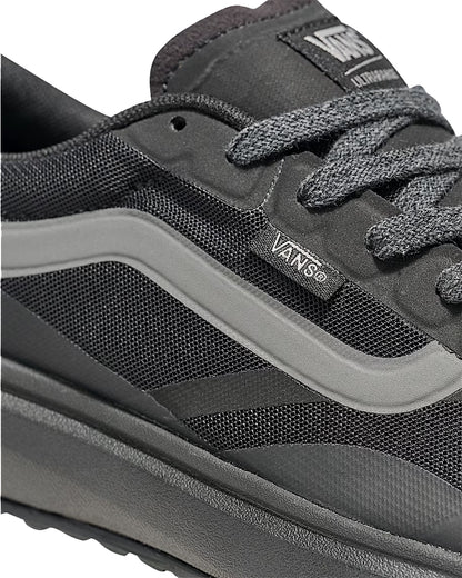 Close-up of a gray Vans sneaker with visible branding.