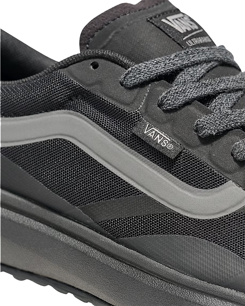 Close-up of a gray Vans sneaker with visible branding.