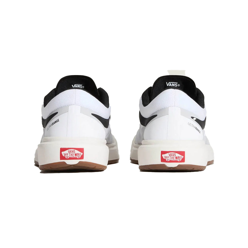 White Vans sneakers with black accents and red labels on a white background
