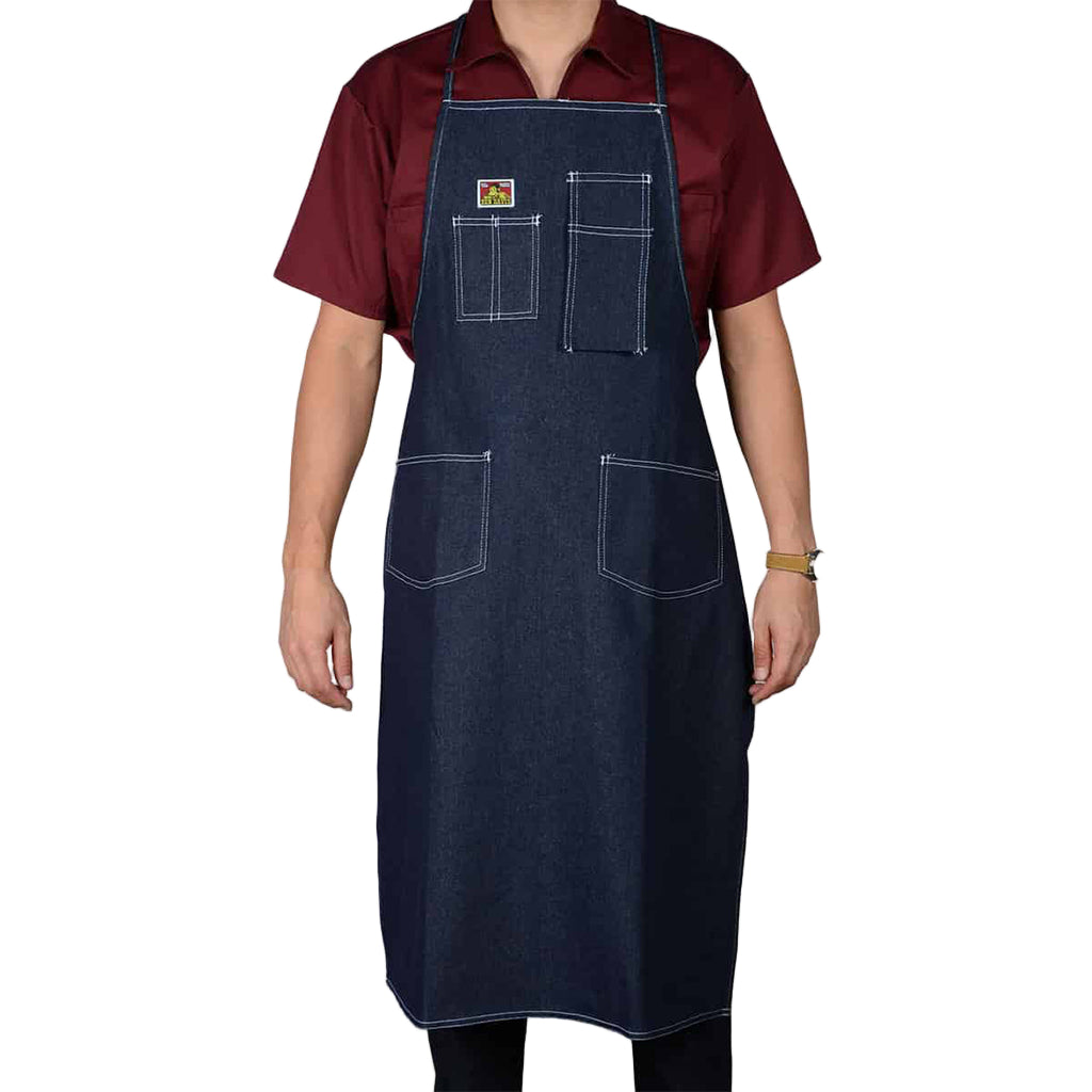 Person wearing a dark denim apron on a white background