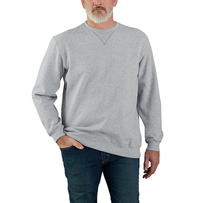 Man wearing a gray sweatshirt and blue jeans on a white background