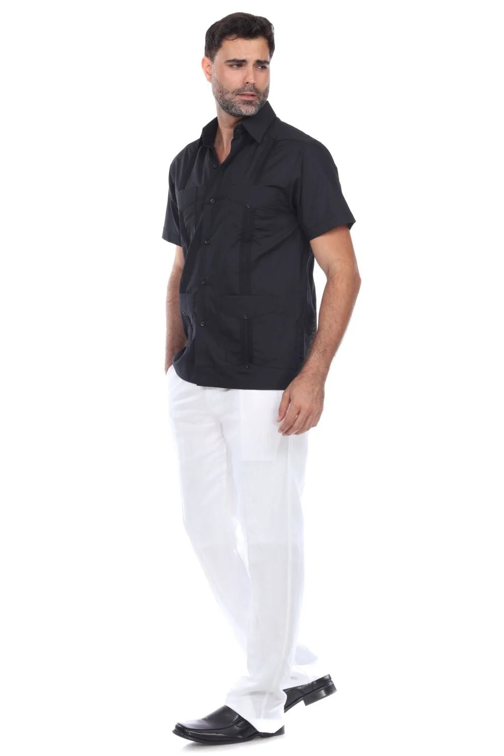 Man wearing a black shirt and white pants on a white background