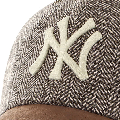 Close-up of a cap with a textured pattern and embroidered logo on a white background