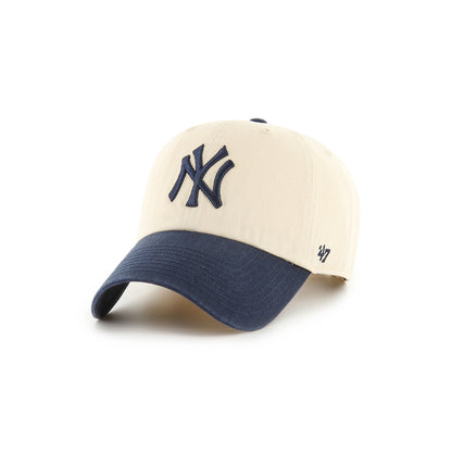 Beige and navy baseball cap with '47' brand logo on a white background