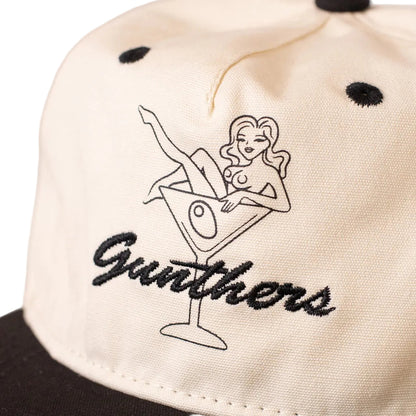 Cap with embroidered design of a woman in a martini glass and 'Gunthers' text.