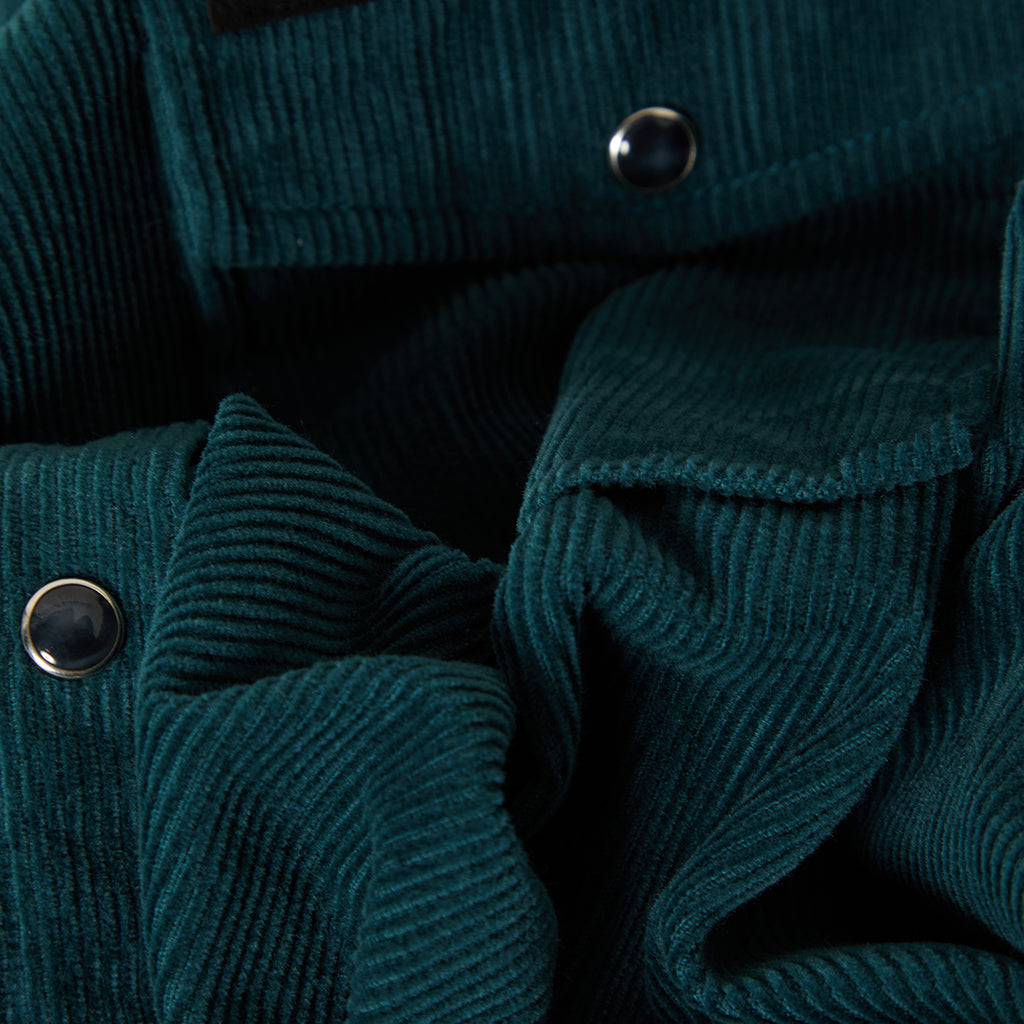 Close up of pearl snaps and green corduroy overshirt 
