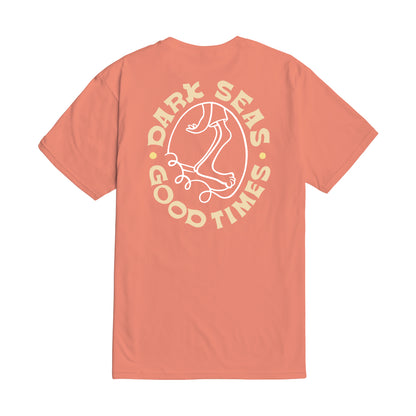 Coral t-shirt with 'Dark Seas Good Times' graphic on a white background