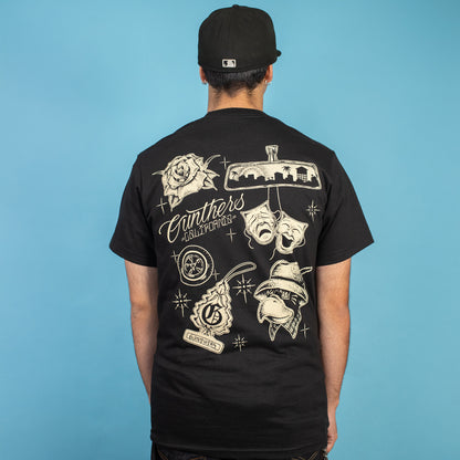 Person wearing a black t-shirt with white graphics and text on the back against a blue background