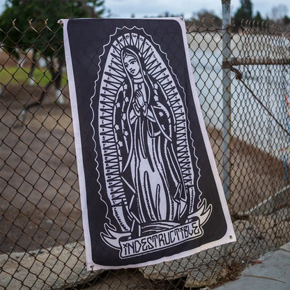 Poster of a religious figure with 'Indestructible' text against a chain-link fence.