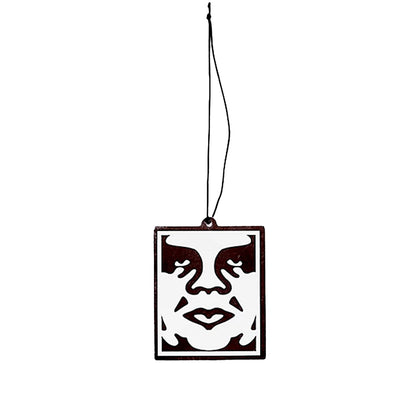 Decorative hanging face ornament with a black border on a white background
