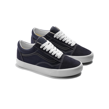 A pair of classic low-top canvas sneakers in navy blue with white laces and white rubber soles, shown on a clean white background.