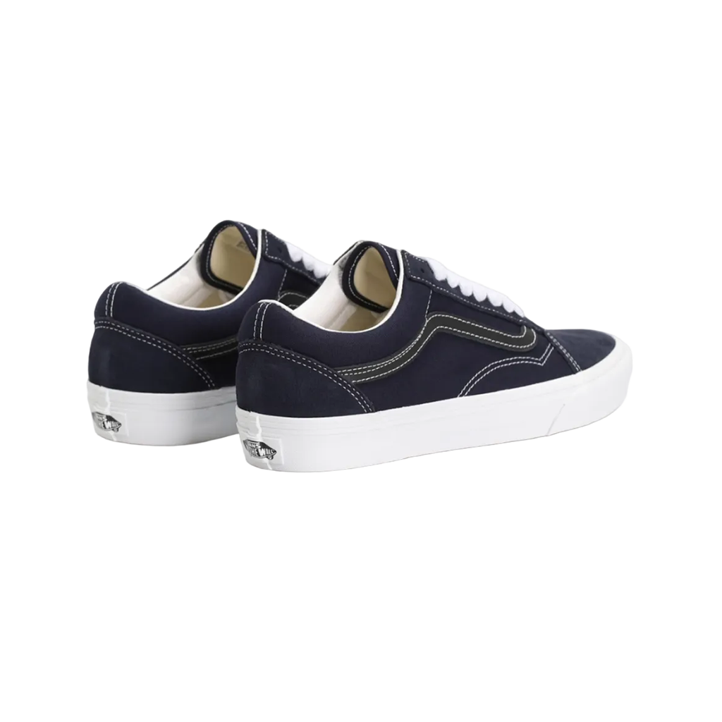 A pair of Vans Old Skool sneakers in navy blue canvas with white laces and white rubber soles, shown from a three-quarters angle on a white background.