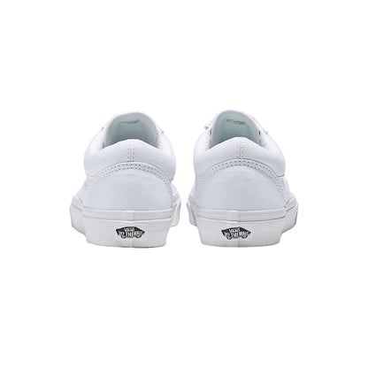 White sneakers with Vans logo on a light gray background