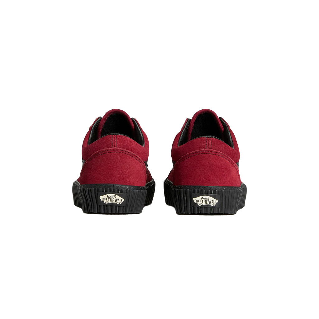 Red slip-on shoes with black soles on a white background