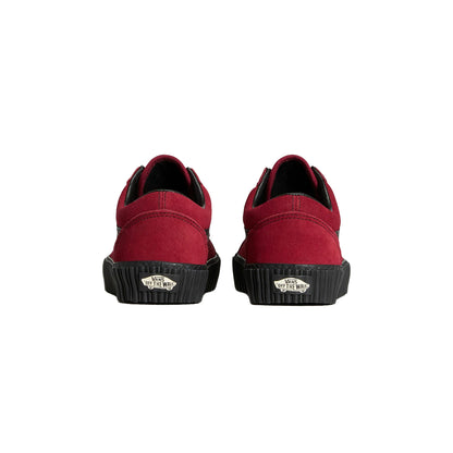 Red slip-on shoes with black soles on a white background