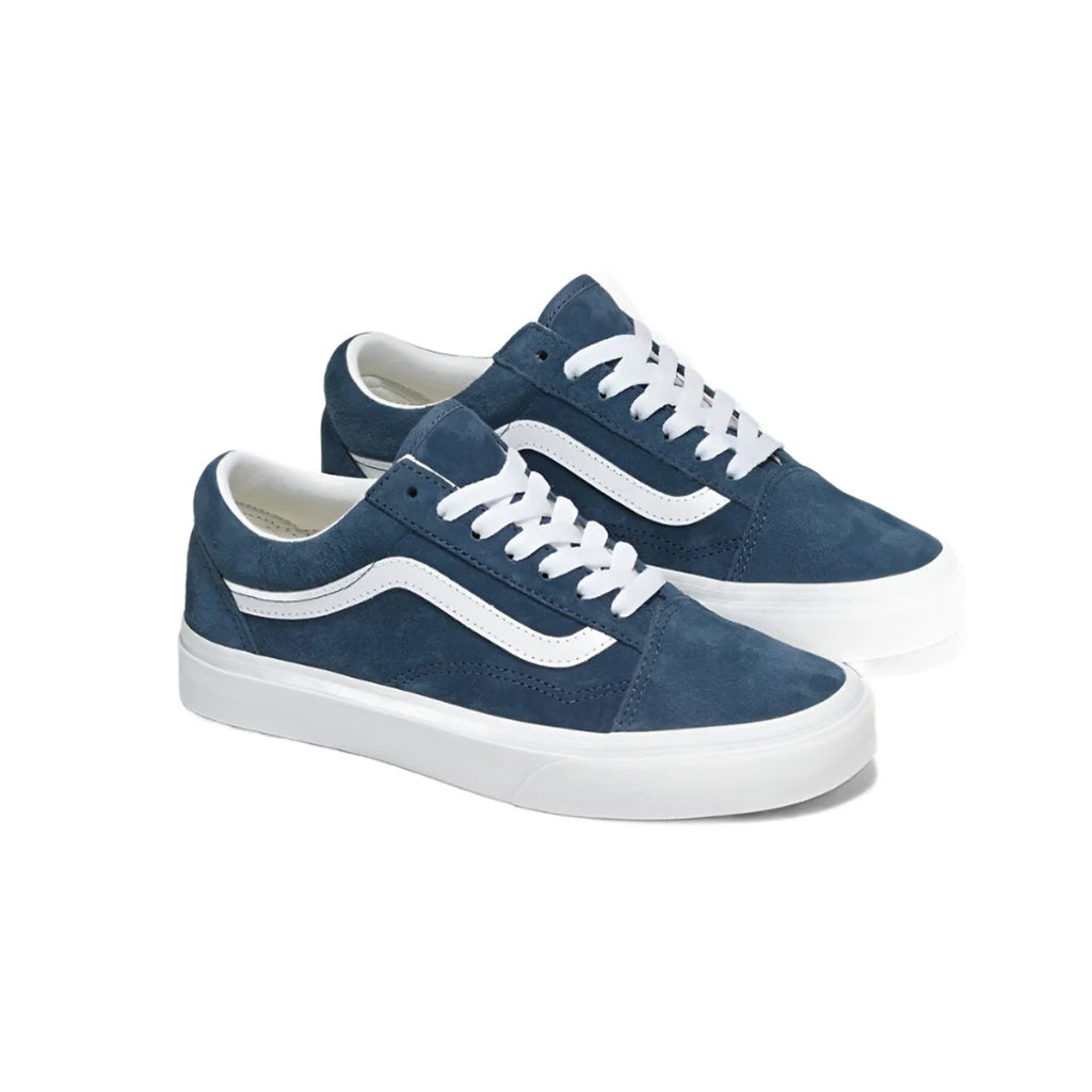 Pair of blue sneakers with white soles on a white background