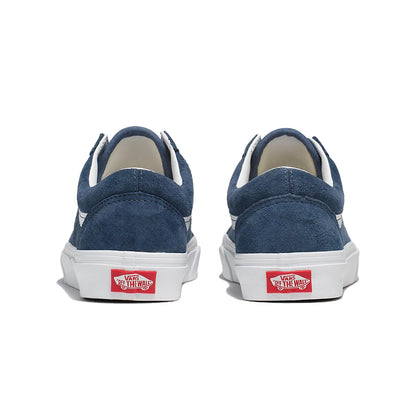 Blue sneakers with white soles and red Vans logo on a white background