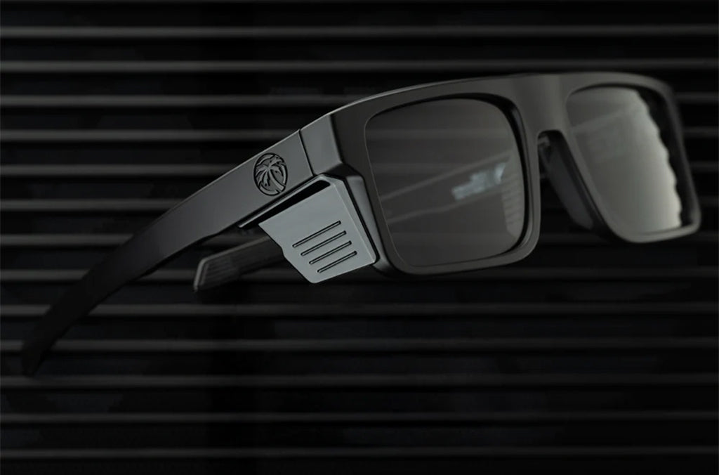 Black sunglasses with a logo on a dark background