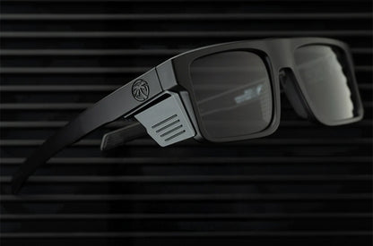 Black sunglasses with a logo on a dark background