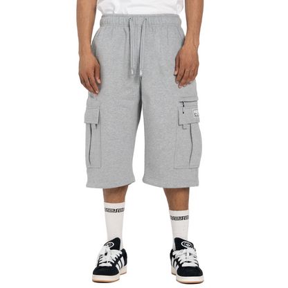 Person wearing gray cargo shorts on a white background