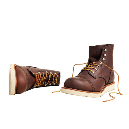 Brown leather boots with white soles on a white background