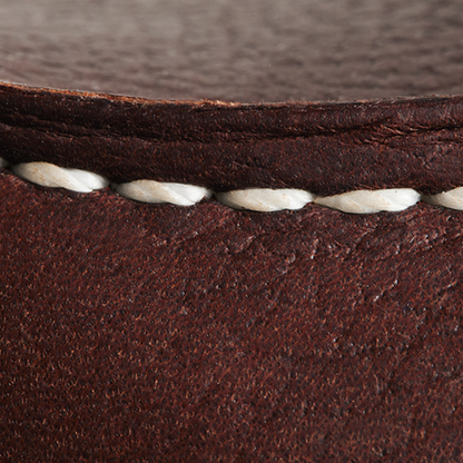 Close-up of brown leather with white stitching
