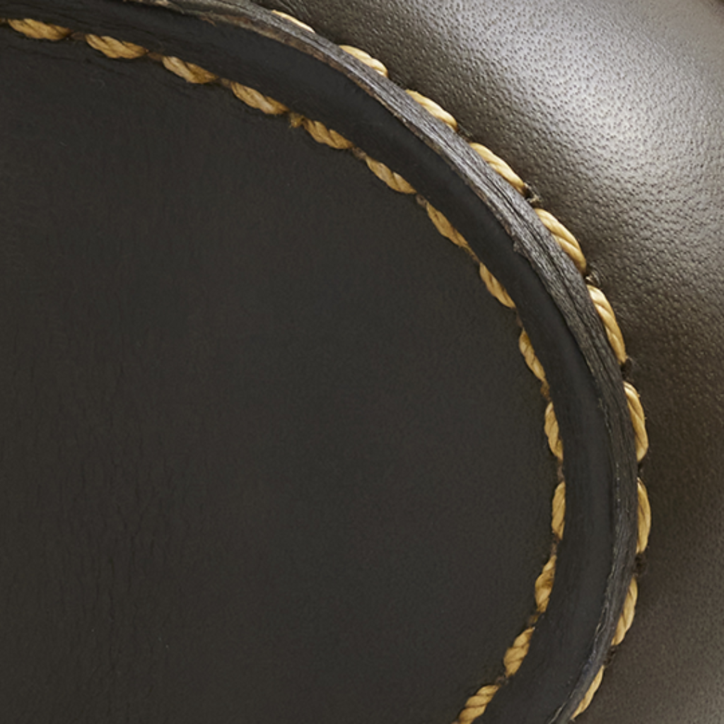 Close-up of black leather with gold stitching