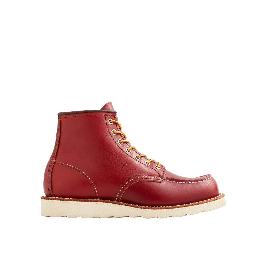Red leather boot with yellow laces on a white background