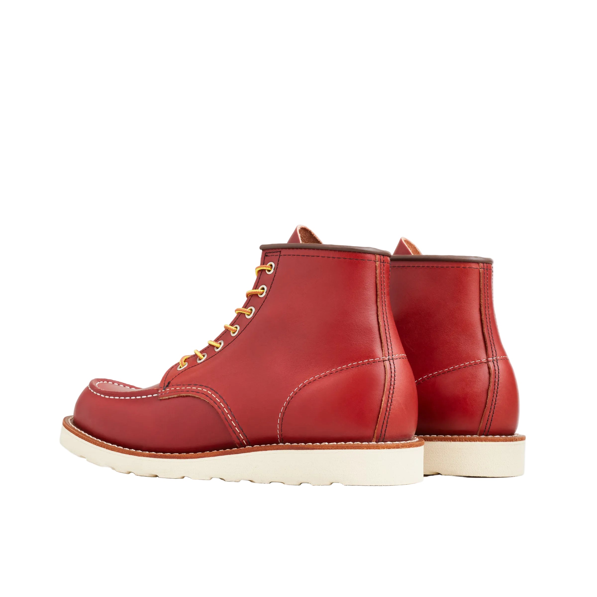 Red leather boots with white soles on a white background