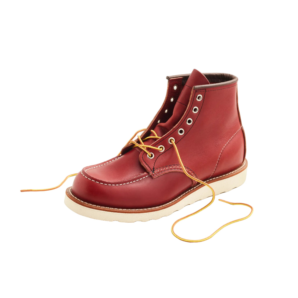 Red leather boot with yellow laces on a white background