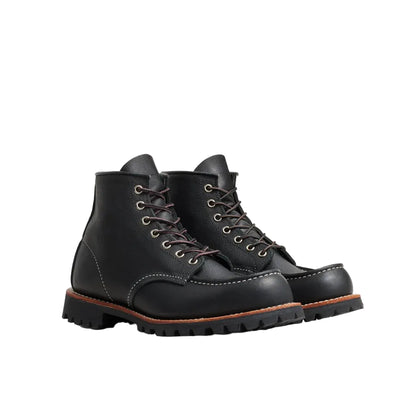 Pair of black leather boots on a white background