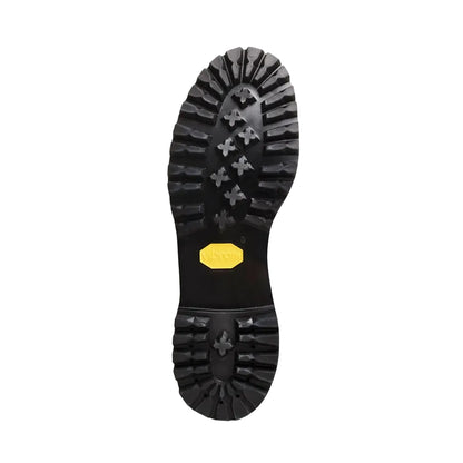 Close-up of a black boot sole with a yellow label on a white background