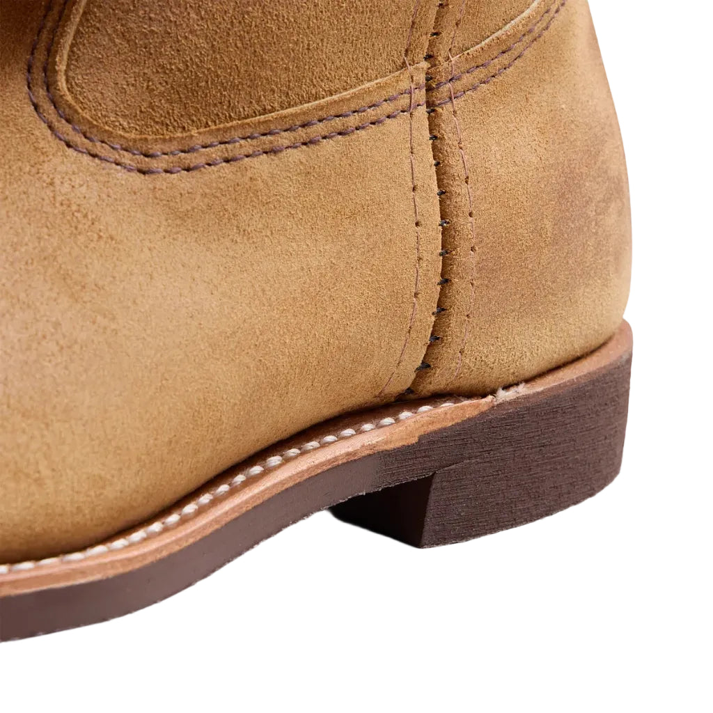 Close-up of a brown leather boot on a white background