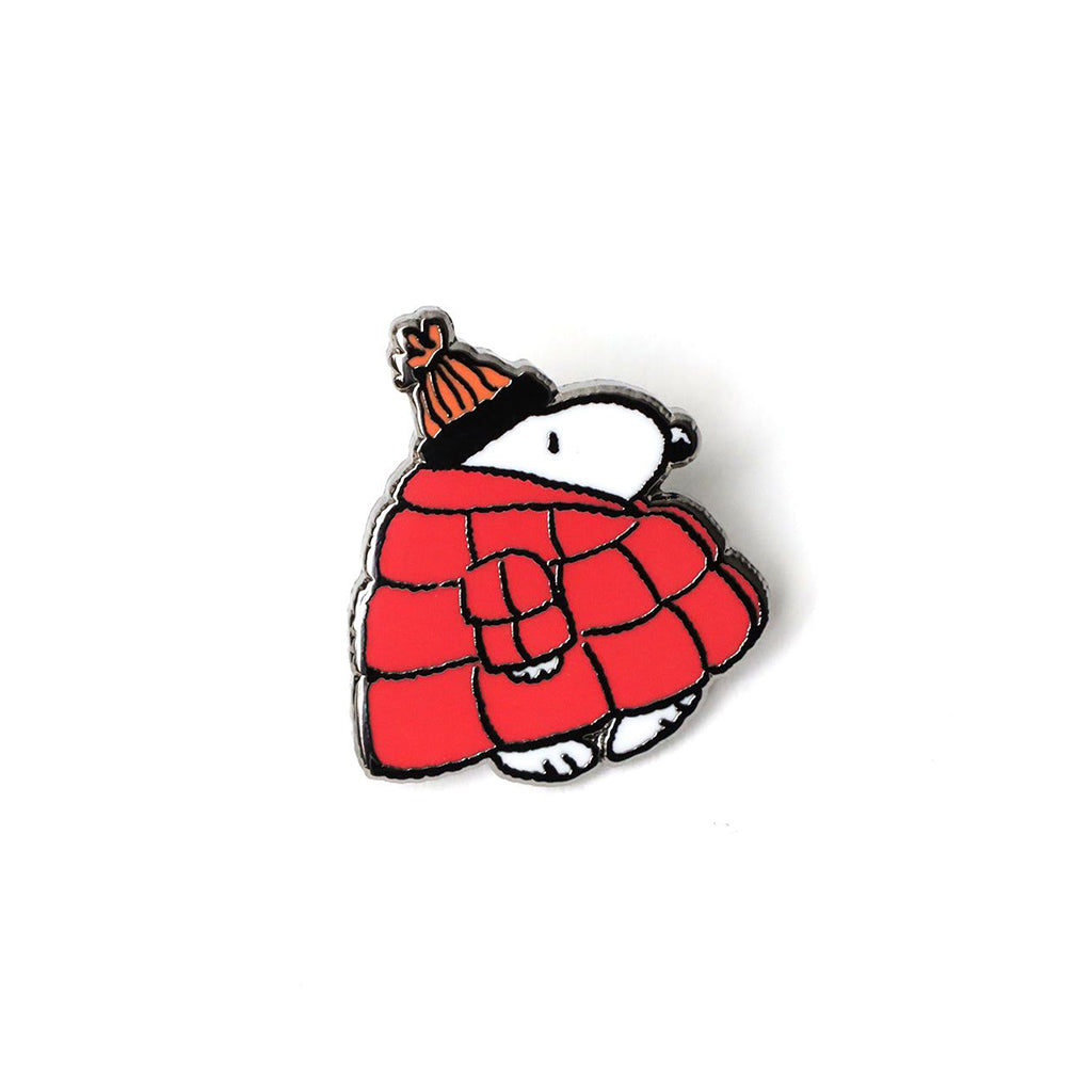 Pin with Snoopy wearing a red coat and orange hat on a white background