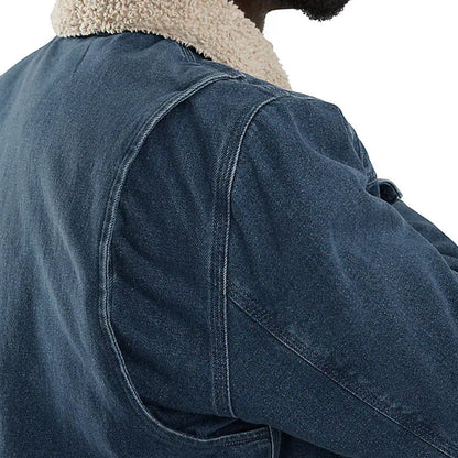 Close-up of a blue denim jacket with a beige sherpa lining on a white background