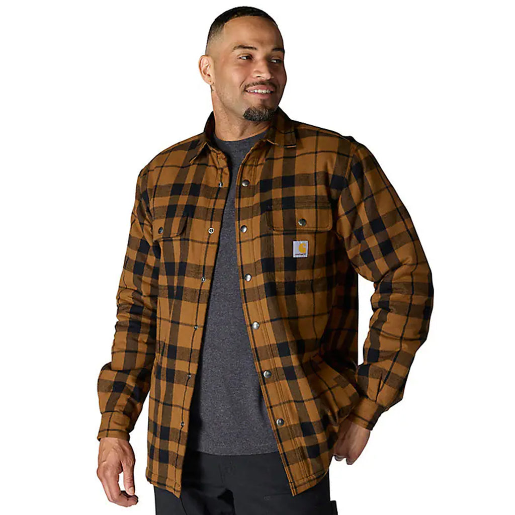 Man wearing a brown and black plaid shirt on a white background