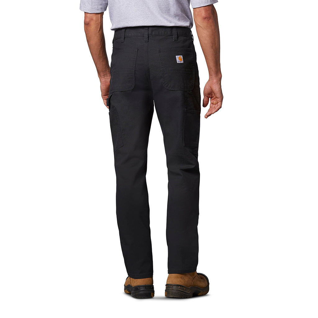 Person wearing black Carhartt work pants on a white background