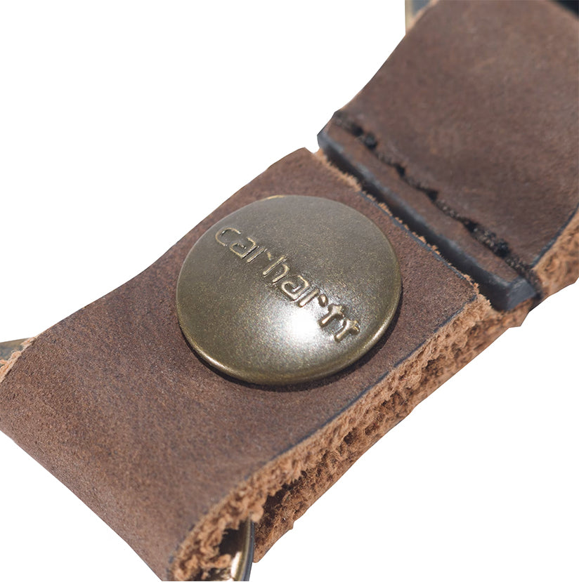Close-up of a brown leather strap with a metal button featuring the Carhartt logo on a white background.