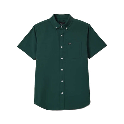 Green short-sleeve shirt with white buttons on a white background