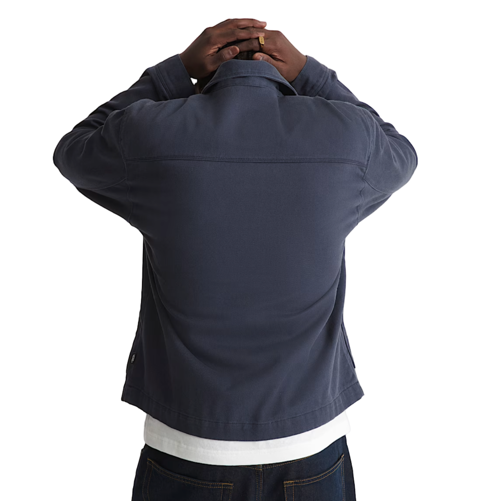 Person wearing a navy jacket on a white background