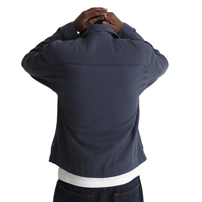 Person wearing a navy jacket on a white background