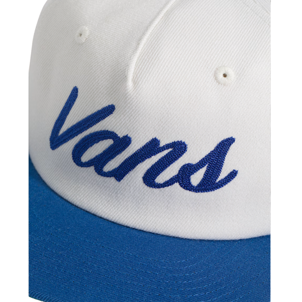 Close-up of a white and blue Vans cap with embroidered logo.