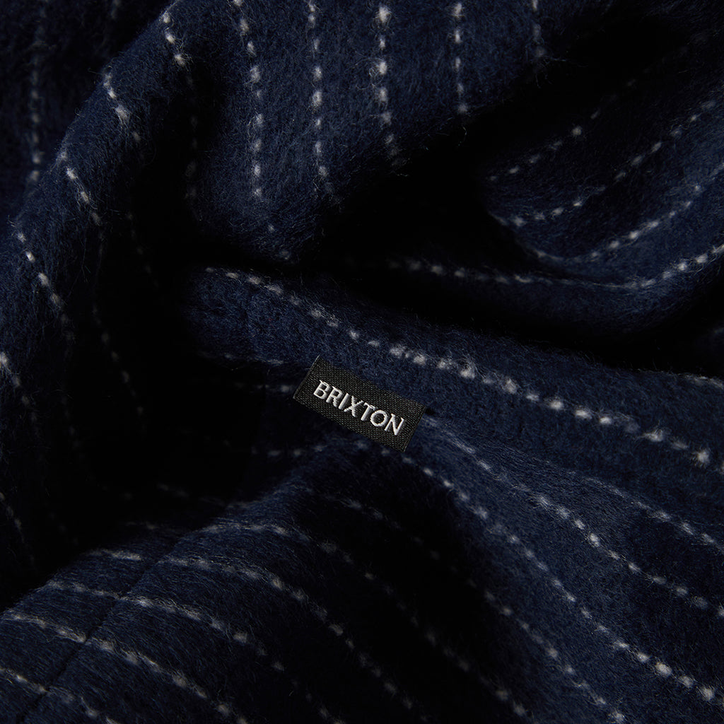 Navy fabric with white stitching and Brixton label