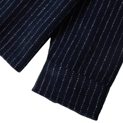 Close-up of a navy pinstripe fabric on a white background