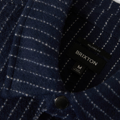 Navy checkered jacket with Brixton label on a dark background