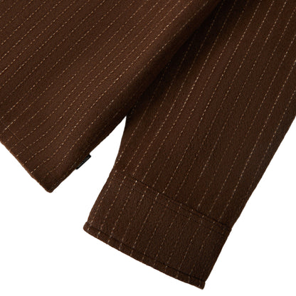 Close-up of brown pinstripe pants on a white background