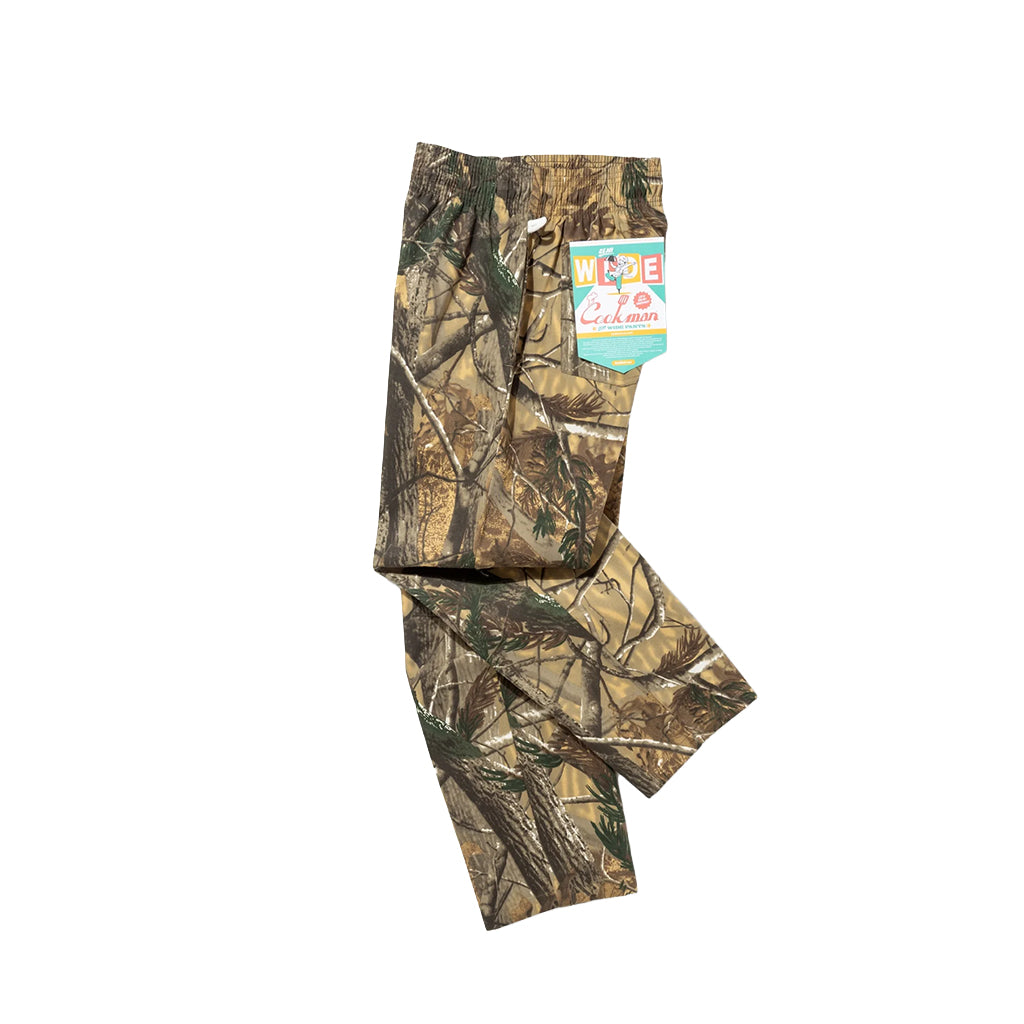 Camouflage pants with a visible brand tag on a white background