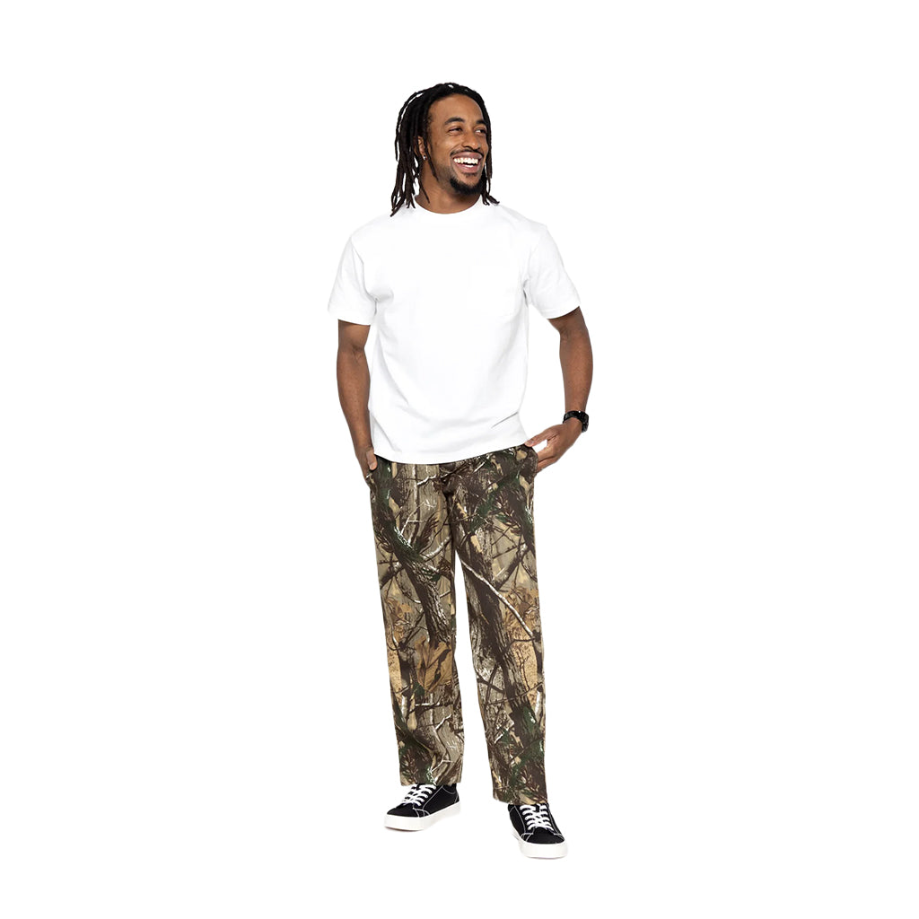 Person wearing a white t-shirt and camouflage pants on a white background