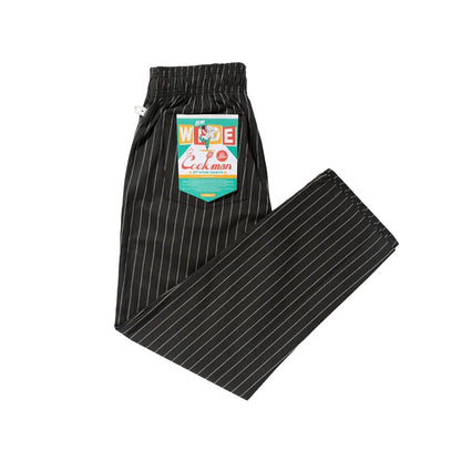 Black pinstripe pants with a colorful label on a white background