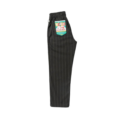 Black pinstripe pants with a brand label on a white background